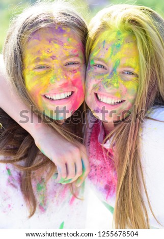 Teenager friends with dry colors. Colorful holi on painted face Drycolors. Teenage school friends having fun piggybacking outdoors with dry colors. Happy mood with colorful drycolors Stock photo © 