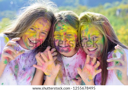 Teenager friends with dry colors. Drycolors. Teenage school friends having fun piggybacking outdoors with dry colors. Happy mood with colorful drycolors. Colorful holi on painted face Stock photo © 
