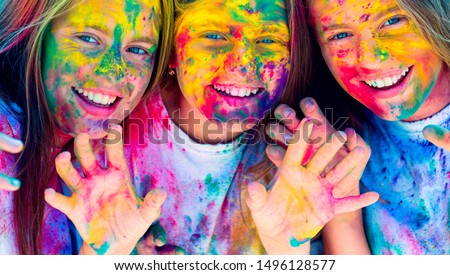 Teenager friends with dry colors. Drycolors. Teenage school friends having fun piggybacking outdoors with dry colors. Happy mood with colorful drycolors. Colorful holi on painted face Stock photo © 