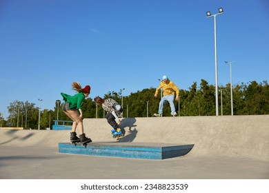 Teenager friends having recreation time in urban skate park - Powered by Shutterstock