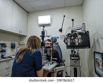 Teenager Girl 14 Years Old In Ophthalmology Office, Equipment Commonly Seen In An Eye Doctor Room, New York, United States, 06.05.2021