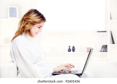 Teenager Girl In Bathrobe At Home With Computer