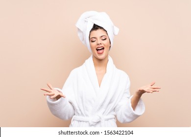 Teenager girl in a bathrobe over isolated background unhappy and frustrated with something - Powered by Shutterstock