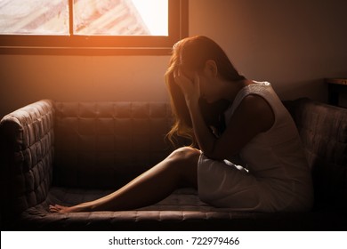 Teenager Girl With Depression Or Sad Sitting Alone In The Dark Room. Major Depressive Disorder. Lonely Concept And Health Problems.