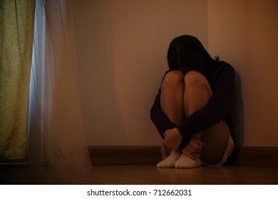 Teenager Girl With Depression Sitting Alone In The Dark Room. Major Depressive Disorder.