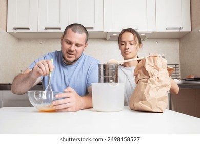 Teenager girl and father preparing baking together, parent-child bonding time, mixing ingredients and enjoying baking. - Powered by Shutterstock