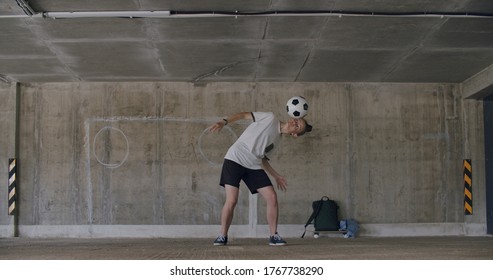 Teenager Girl Football Soccer Player Doing Ball Tricks Inside Empty Covered Parking Garage. Urban City Lifestyle Outdoors Concepte. 4K UHD Slow Motion RAW Graded Footage