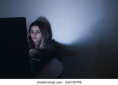 Teenager girl to have dependence on computer. late night watching TV series on  laptop and playing online games