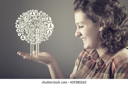 Teenager girl holding a circuit board tree, network concept