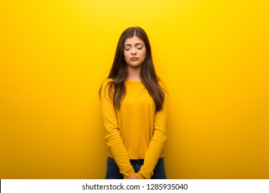 Teenager Girl On Vibrant Yellow Background With Sad And Depressed Expression