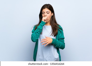 Teenager Girl Over Blue Wall Is Suffering With Cough And Feeling Bad