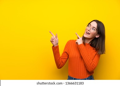 Teenager Girl Over Blue Wall Pointing With The Index Finger A Great Idea