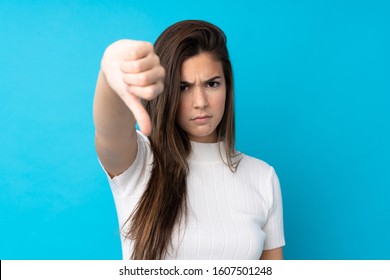 Teenager Girl Over Isolated Blue Background Showing Thumb Down With Negative Expression