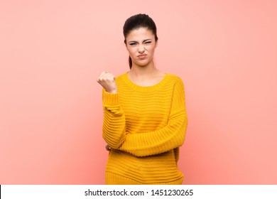 Teenager Girl  Over Isolated Pink Wall With Angry Gesture