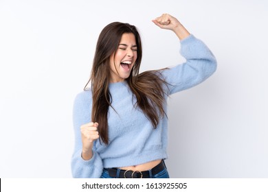 Teenager girl over isolated white background celebrating a victory