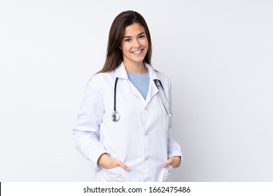 Teenager girl over isolated white background wearing a doctor gown and with stethoscope