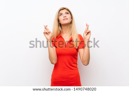 Teenager girl over isolated white background with fingers crossing and wishing the best