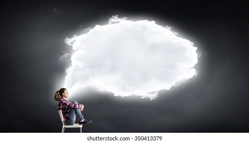 Teenager girl sitting in chair and cloud bubble above her head - Shutterstock ID 350413379