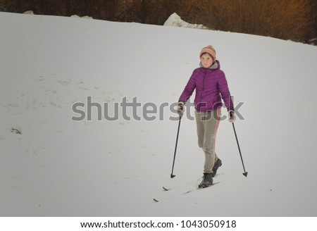 teenager girl ski in winter snowy park