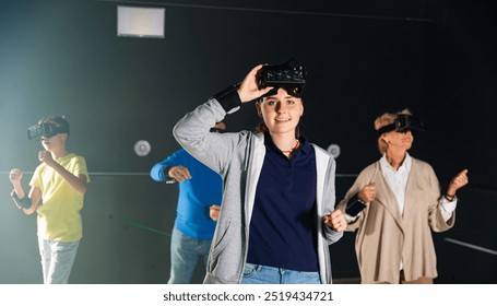 Teenager girl standing and looking in camera while playing VR games with her family. - Powered by Shutterstock