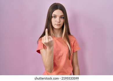 Teenager Girl Standing Over Pink Background Showing Middle Finger, Impolite And Rude Fuck Off Expression 