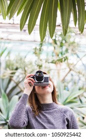 Teenager girl take a photo in the botanical garden