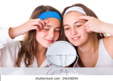 Teenager girls searching for blemishes on theirs skin