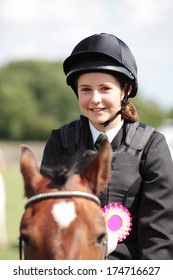 A Teenager Happy To Have Won A Rosette Horse Riding