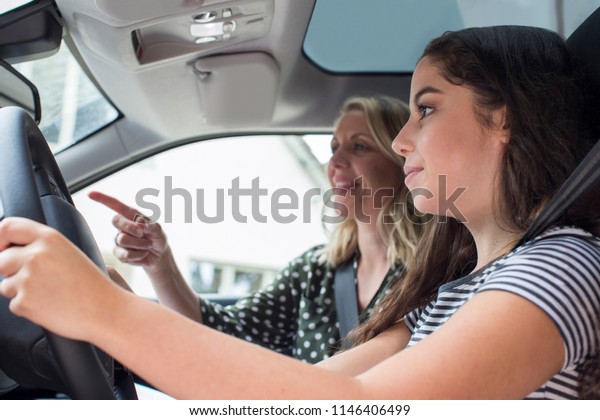 Teenager\
Having Driving Lesson With Female\
Instructor