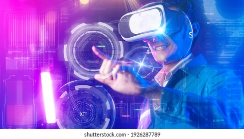 Teenager having fun play VR virtual reality glasses sport game 3D cyber space futuristic neon colorful background, future digital technology game and entertainment - Shutterstock ID 1926287789