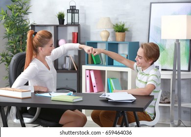 Teenager Having Therapy Session With Therapist At Office