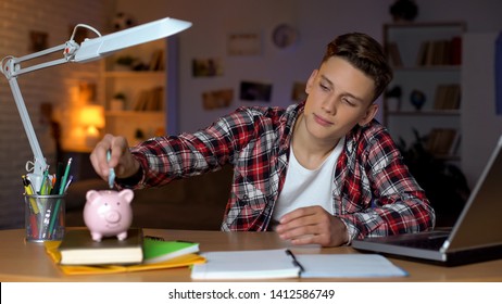 Teenager Holding Euro Banknote Putting It To Piggyback, Financial Education