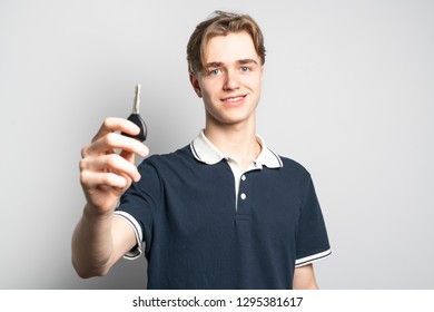 A Teenager Holding The Key Of His First Car