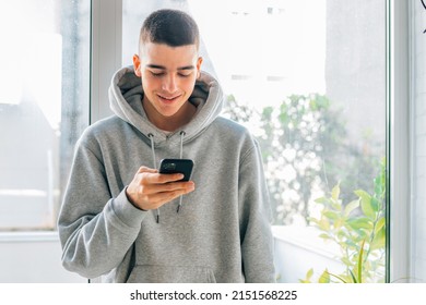 teenager at home with mobile phone