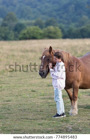 Teenager with Horses in a meadow of Navarra, Spain.