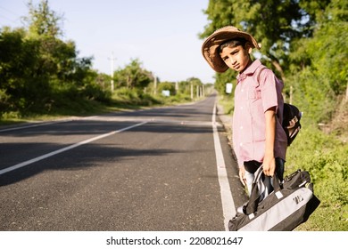 Teenager Indian Kid Waiting For Bus Or Taxi On Highway Road During Holiday Trip - Concept Of Traveling, Weekend Holidays And Liesure Lifestyle.