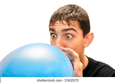 Teenager inflating big blue balloon