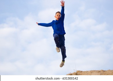 Teenager Jumping Against The Sky. Parkour On The Sand