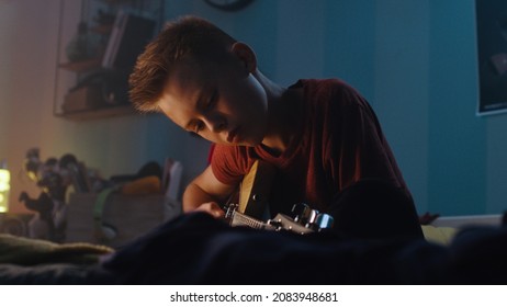 Teenager Learning To Play Guitar