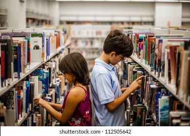 Teenager In A Library Are Reading Books