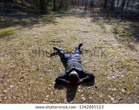 teenager lies on the ground in spring in the sun