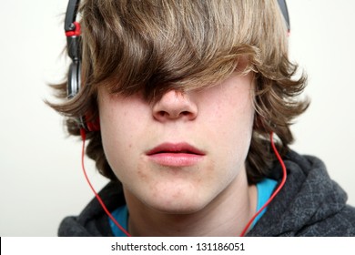 Teenager Listening To Music, Hiding Behind His Hair