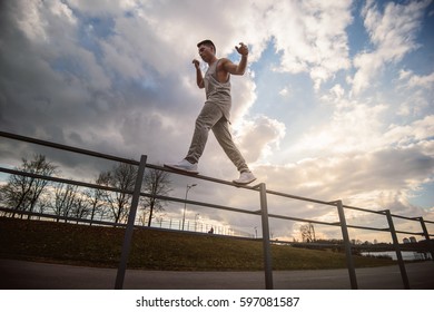 Teenager Makes Acrobatic Moves In Park Parkour