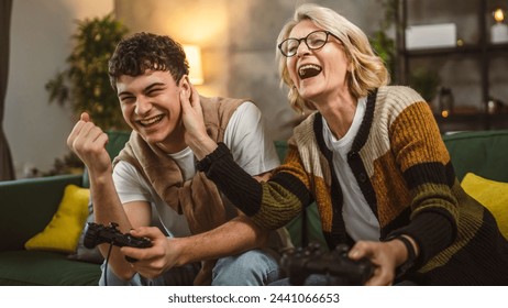 teenager male and his mother mature woman man play console video game - Powered by Shutterstock