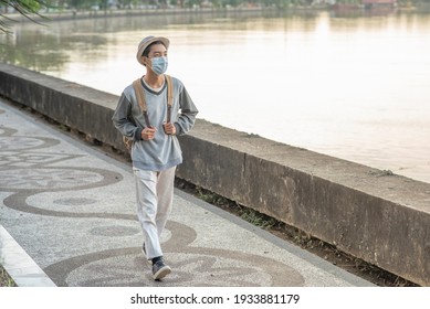 Teenager Man Walking Outside The River On The Road With Protective Face Mask