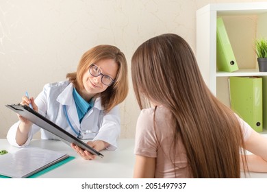 Teenager At Medical Consultation With A Doctor In Medical Office