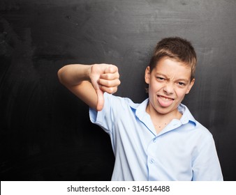 Teenager Near Blackboard Showing Dislike. Child At School. Student At Classroom