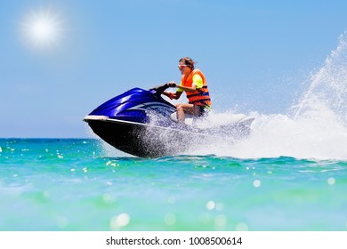 Teenager On Jet Ski. Teen Age Boy Skiing On Water Scooter. Young Man On Personal Watercraft In Tropical Sea. Active Summer Vacation For School Child. Sport And Ocean Activity On Beach Holiday