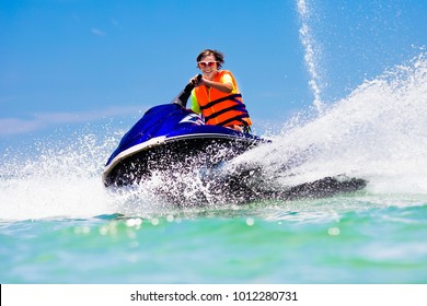 Teenager On Jet Ski. Teen Age Boy Skiing On Water Scooter. Young Man On Personal Watercraft In Tropical Sea. Active Summer Vacation For School Child. Sport And Ocean Activity On Beach Holiday.