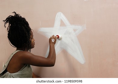 Teenager Painting On A Wall